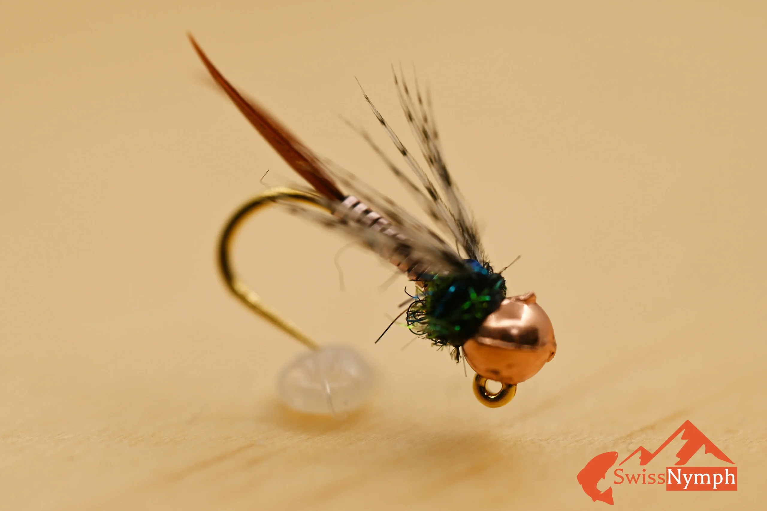 Die Copper John Nymphe ist ein moderner Klassiker im Fliegenfischen und hat sich als universelles Muster für Forellen und Äschen in unterschiedlichsten Gewässern bewährt. Dank ihres kupfernen Drahtkörpers sinkt sie besonders schnell – ideal für tiefe Gumpen, starke Strömung oder als Ankerfliege beim Czech Nymphing.